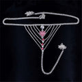 A silver rhinestone panty body jewelry with a central pink heart pendant and red gemstone garter belt accents