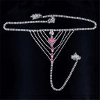 A silver rhinestone panty body jewelry with a central pink heart pendant and red gemstone garter belt accents