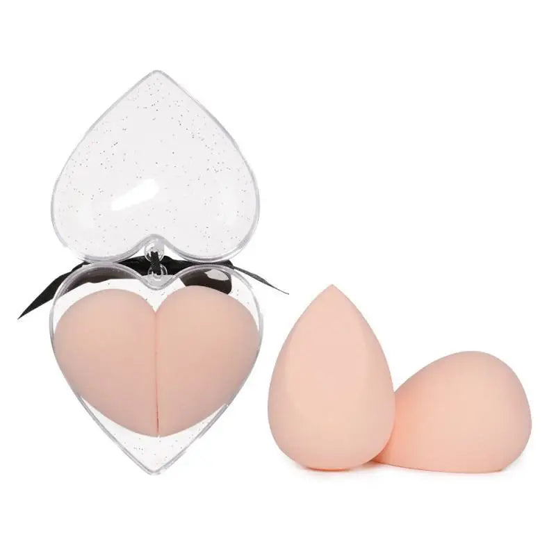 Heart shaped beauty egg makeup sponges in peach silicone in a clear glittery heart case with black ribbon gift box