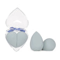 Heart shaped beauty egg makeup gift box with clear plastic case blue ribbon and two light gray egg makeup sponges