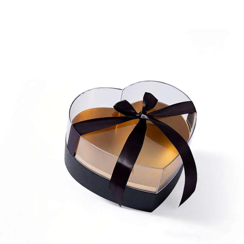 Heart shaped transparent flower packing box with black base and glossy black satin ribbon bow on top