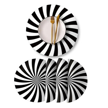Black and white spiral patterned ceramic dinner plates on heat resistant round leather placemats set of 4
