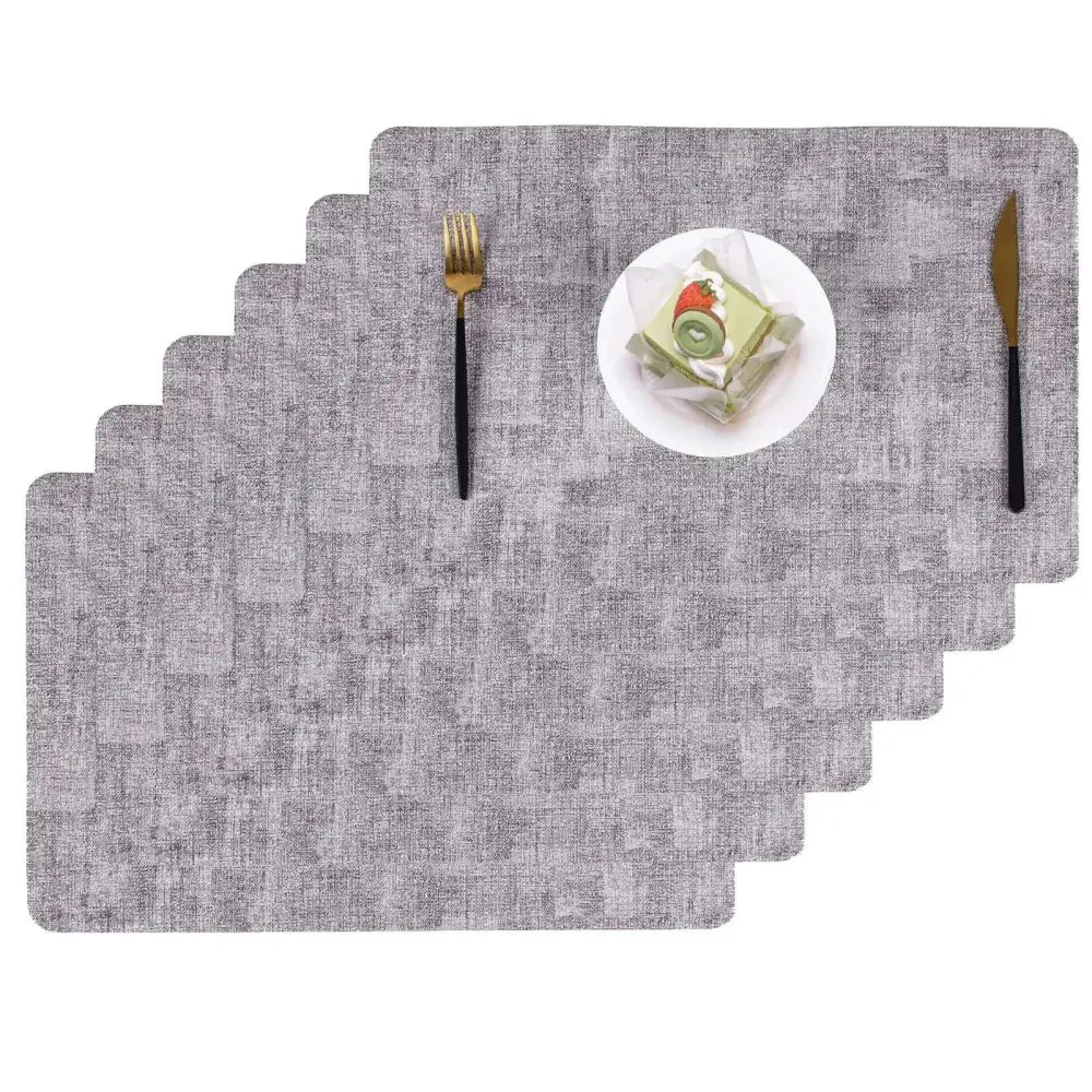 Heat resistant textured gray dining table placemats with a subtle woven pattern for durable dining table protection