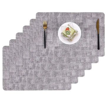 Heat resistant textured gray dining table placemats with a subtle woven pattern for durable dining table protection