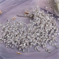 A heavy handmade rhinestone snow queen wedding crown with sparkling silver crystal leaves and branch patterns