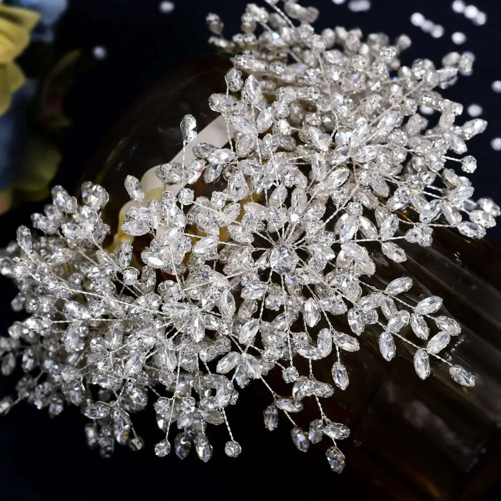 A heavy handmade rhinestone sparkling silver crystal snow queen wedding crown with a delicate floral design