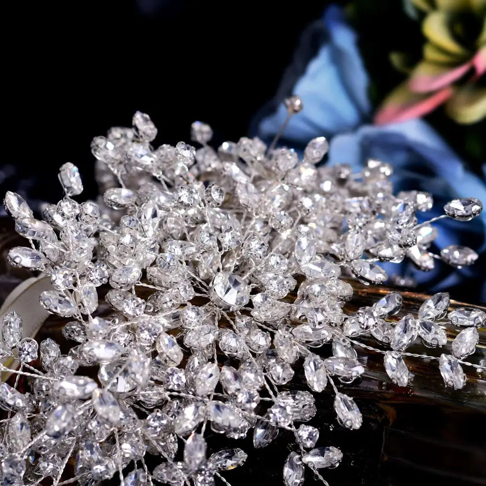 A heavy handmade rhinestone snow queen wedding crown featuring a sparkling silver crystal hair vine with floral design