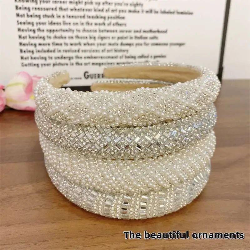A multi-layered heavy industry light luxury pearl style headband with intricate beadwork and sparkling silver rhinestones