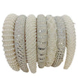 A collection of elegant off-white heavy industry light luxury pearl style headbands with sparkling silver crystal embellishments
