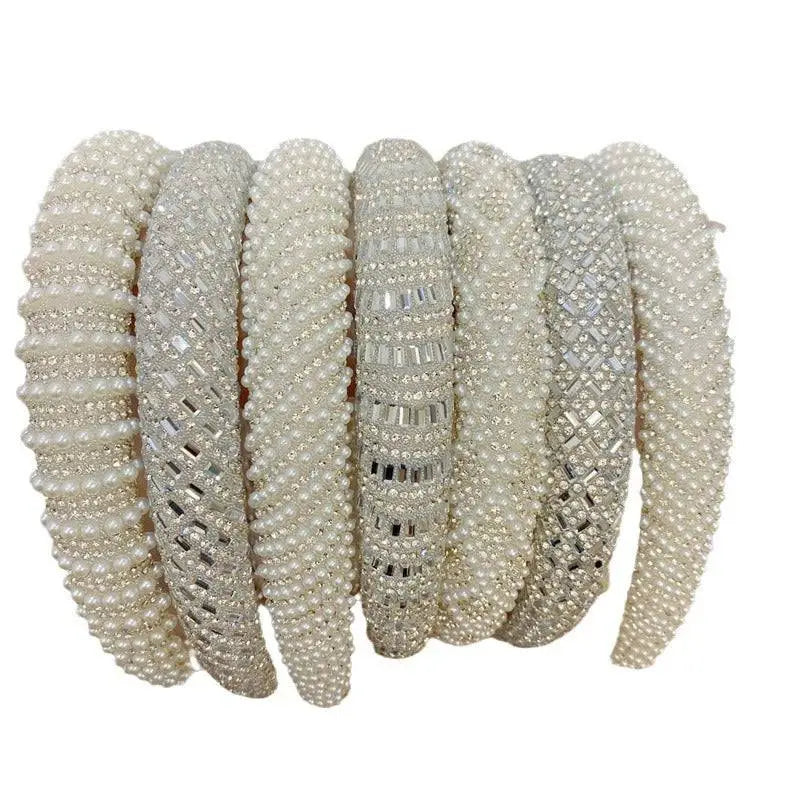 A collection of elegant off-white heavy industry light luxury pearl style headbands with sparkling silver crystal embellishments