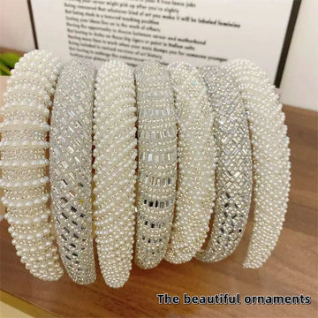 A collection of white heavy industry light luxury pearl style headbands with sparkling silver crystal embellishments