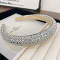 A sparkling silver heavy industry light luxury pearl style headband with geometric baguette and round crystals