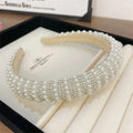 Heavy industry light luxury pearl style headband featuring white pearls and sparkling silver rhinestones on a wide band
