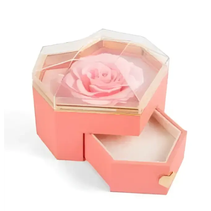 Coral pink hexagonal rose jewelry gift box with glass top, preserved light pink rose inside, gold-trimmed drawers