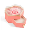 Coral pink hexagonal rose jewelry gift box with glass top, preserved light pink rose inside, gold-trimmed drawers