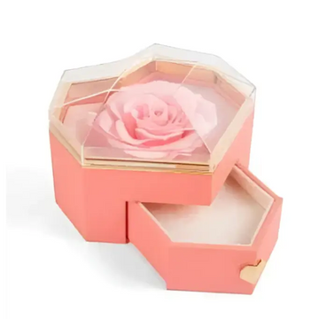 Coral pink hexagonal rose jewelry gift box with glass top, preserved light pink rose inside, gold-trimmed drawers