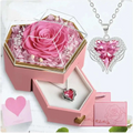 Pink preserved rose in a clear hexagonal glass top jewelry gift box inside a pink rose jewelry gift box