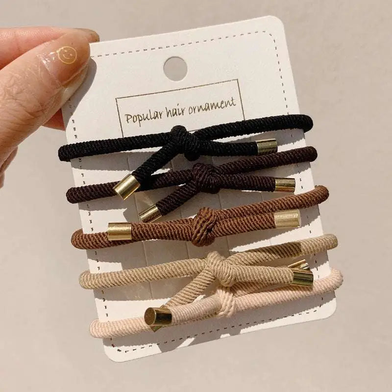 Set of five high elasticity braided wrist hair ties in black brown beige and cream with gold-toned metal ends for secure hair styling