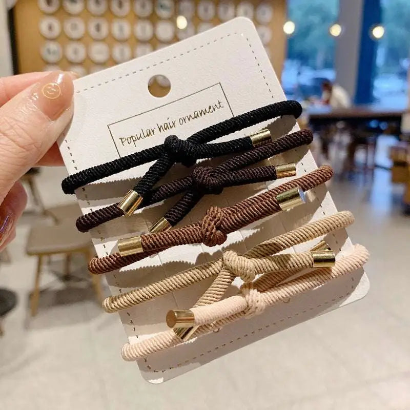 Set of five high elasticity braided wrist hair ties in black brown and beige with gold-tone metal ends for secure hair styling