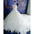 Voluminous white wedding dress wholesale with high neckline, intricate lace, and ruffled big tail cascading skirt