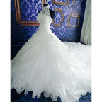 Voluminous white wedding dress wholesale with high neckline, intricate lace, and ruffled big tail cascading skirt