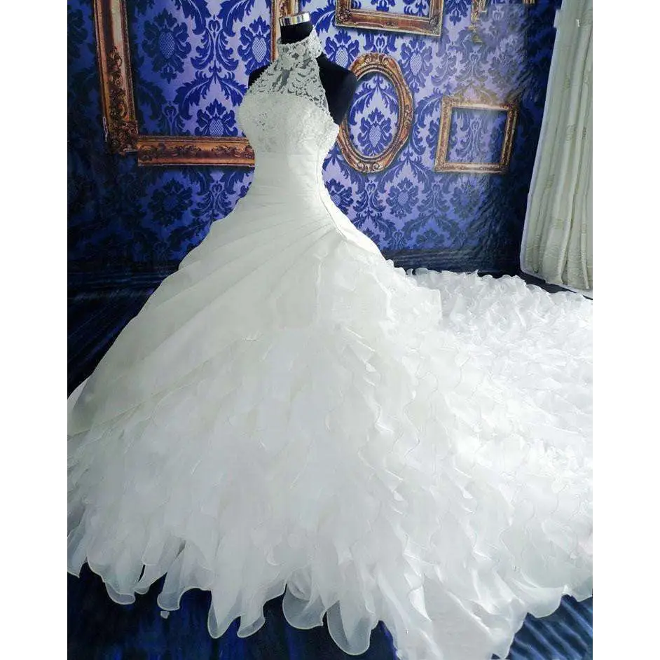 Voluminous white wedding dress wholesale with high neckline, intricate lace, and ruffled big tail cascading skirt