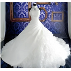 White floor-length wedding dress wholesale with fitted lace bodice and voluminous ruffled big tail skirt