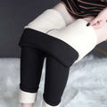 Black high stretch winter leggings with plush white fleece lining and rolled cuffs by royale essence lux