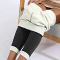 Black high stretch winter leggings with plush white fleece lining and ribbed cuffs by royale essence lux