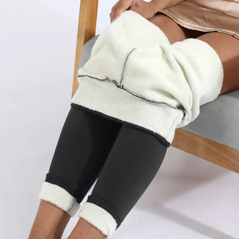 Black high stretch winter leggings with plush white fleece lining and ribbed cuffs by royale essence lux