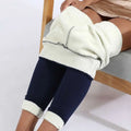 Cream-colored high stretch winter leggings with fleece lining and navy blue outer fabric with rolled cuffs by Royale Essence Lux