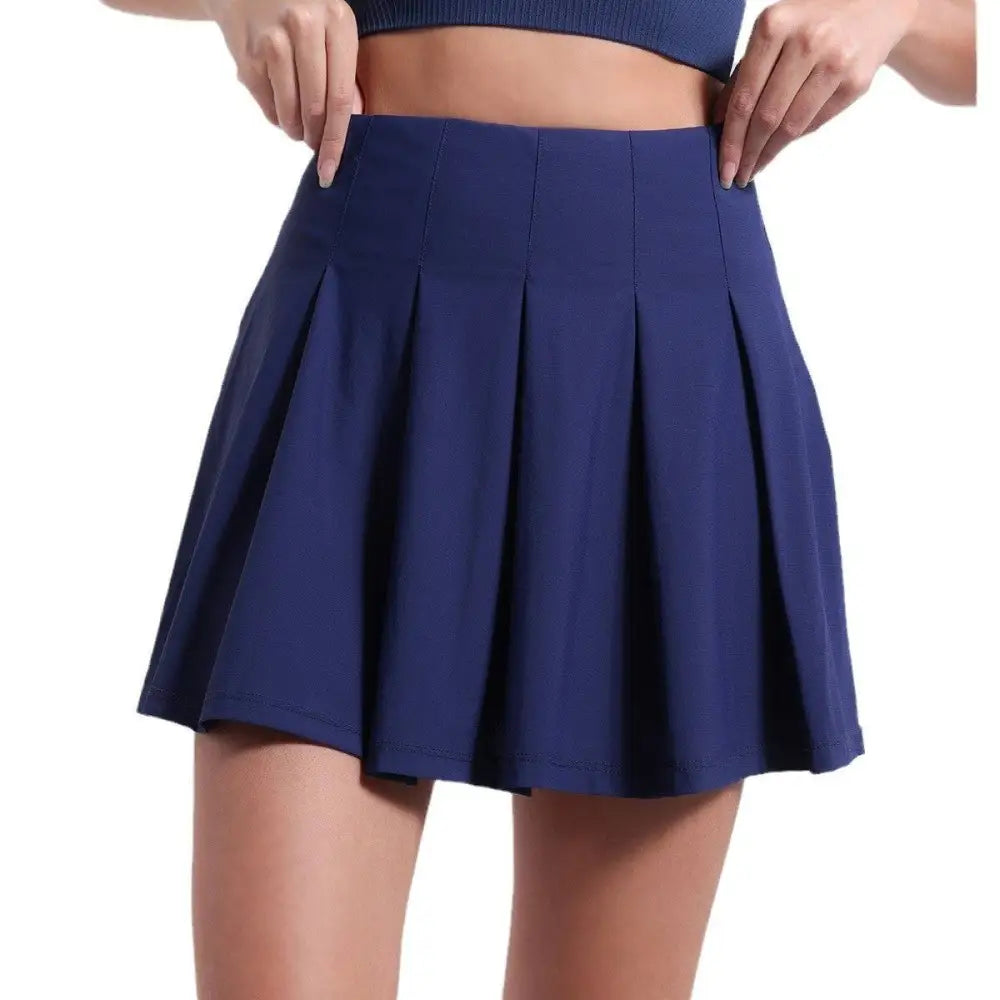 Navy blue pleated skirt with fitted waistband and smooth fabric designed for fitness yoga exercise and aerobics high waist use