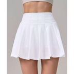 White pleated skirt with high waistband featuring crisp clean lines for fitness yoga exercise and aerobics high waist use
