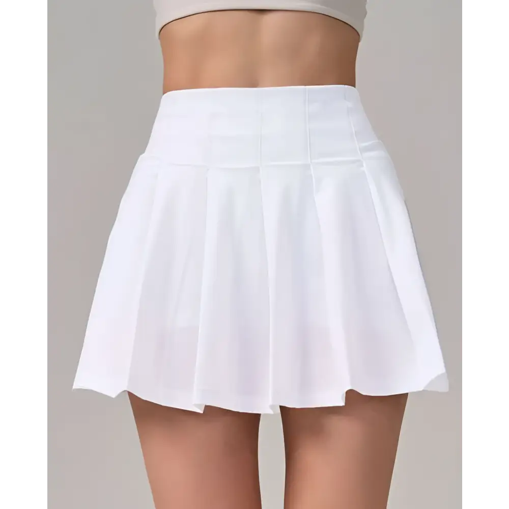 White pleated skirt with high waistband featuring crisp clean lines for fitness yoga exercise and aerobics high waist use