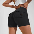 Black high waist hip lifting shorts with ruched back and button flap pockets shown from the back side