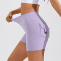 Lavender high waist hip lifting shorts featuring a buttoned side pocket for secure storage during workouts