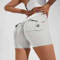 Light gray high waist hip lifting shorts with stretchy fabric and a buttoned flap pocket on the back side