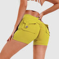Bright yellow high waist hip lifting shorts with ruched back and button-flap pockets, back side view