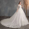 Elegant white lace wedding dress with high waist design and trailing ballgown silhouette featuring three-quarter sleeves