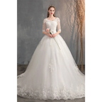 White lace wedding dress with high waist, sheer three-quarter sleeves, embroidered bodice, and trailing skirt
