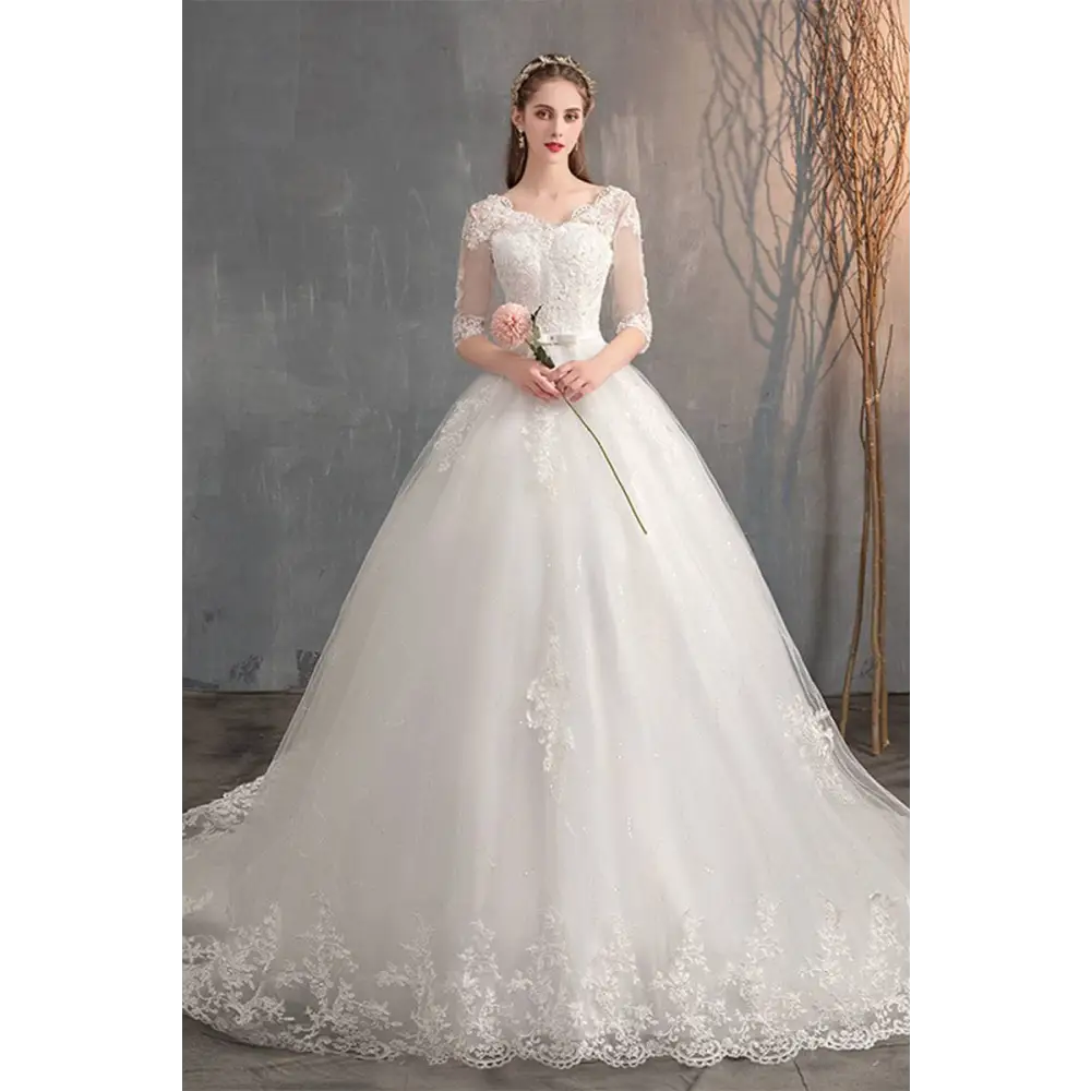 White lace wedding dress with high waist, sheer three-quarter sleeves, embroidered bodice, and trailing skirt