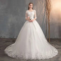 High waist lace wedding dress trailing in white with three quarter length sleeves and a voluminous skirt