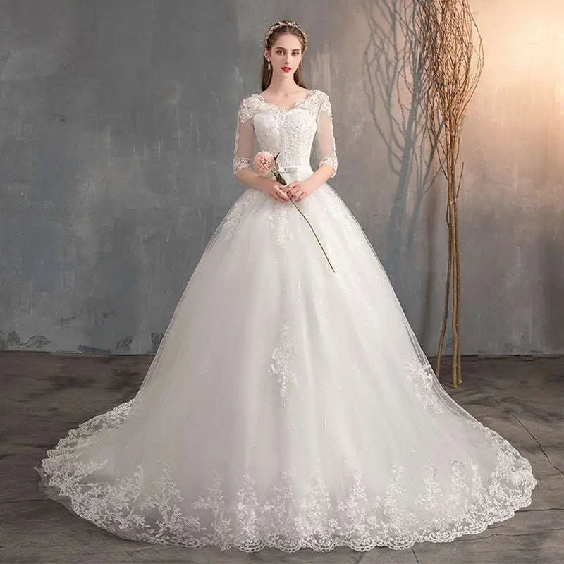 High waist lace wedding dress trailing in white with three quarter length sleeves and a voluminous skirt