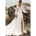 A flowing white long sleeve backless wedding dress with high slit and sheer sleeves for elegant bridal wear