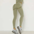 Olive green high waist peach hip yoga pants with textured ribbed panels and subtle horizontal stripe detail