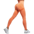 Back view of orange peach hip yoga high waist leggings with textured heathered high waist panel