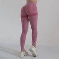High waist peach hip yoga pants in pink heathered fabric with subtle texture and solid bands near the hips
