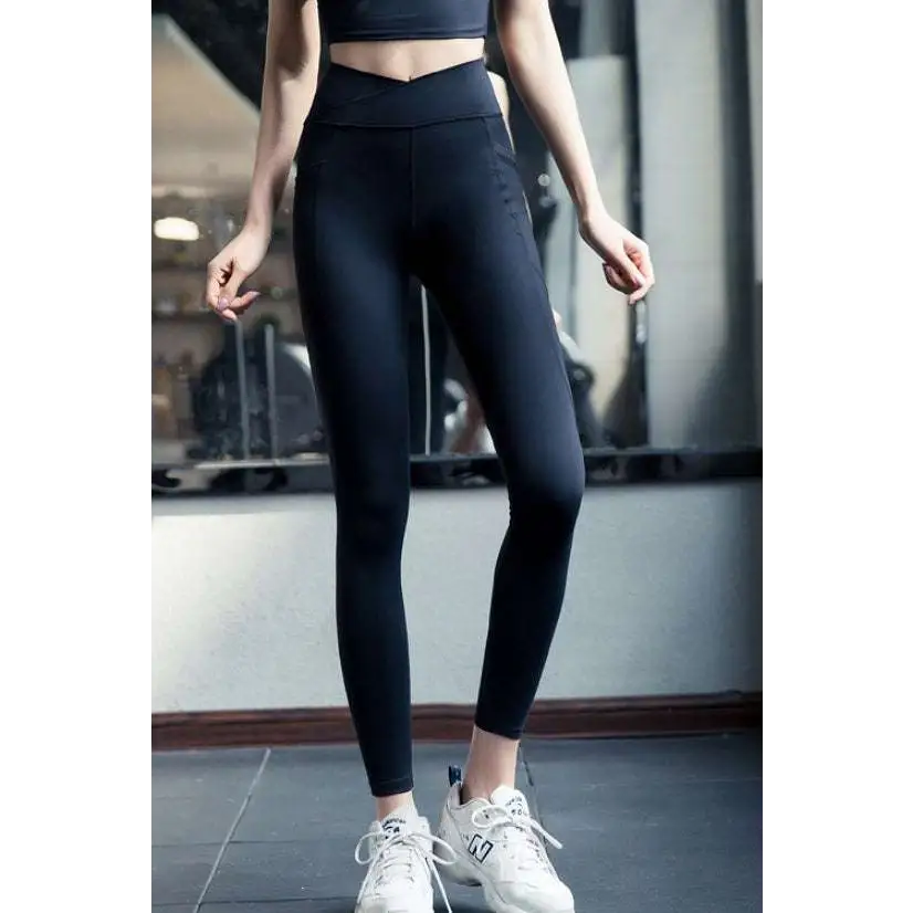 Black high-waisted leggings with sleek design and subtle side pockets in cotton blend for pink yellow yoga set use