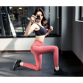 Black sports bra with supportive seamless design paired with high waist pink leggings in cotton blend yoga set