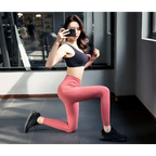 Black sports bra with supportive seamless design paired with high waist pink leggings in cotton blend yoga set